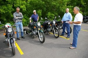 Royal Enfield demo riders, from left, Scott Ewen of Teryville, Glenn Winn of Winsted and Karl Duerr of Canton are briefed prior to the ride by Ron Greene, vice president of sales and dealer development for Royald Enfield. Bud Wilkinson / Republican-American