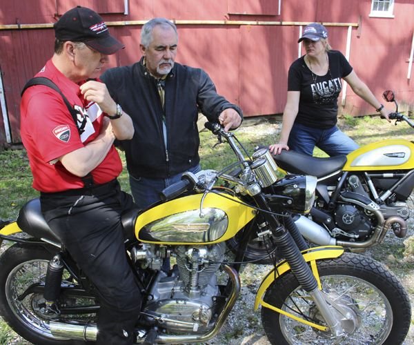 Matthew Phillips, center, tells Chris Green of New Haven Powersports about his 1969 Ducati 450 SCR as Jodi Green from the dealership listens in. Bud Wilkinson / Republican-American  