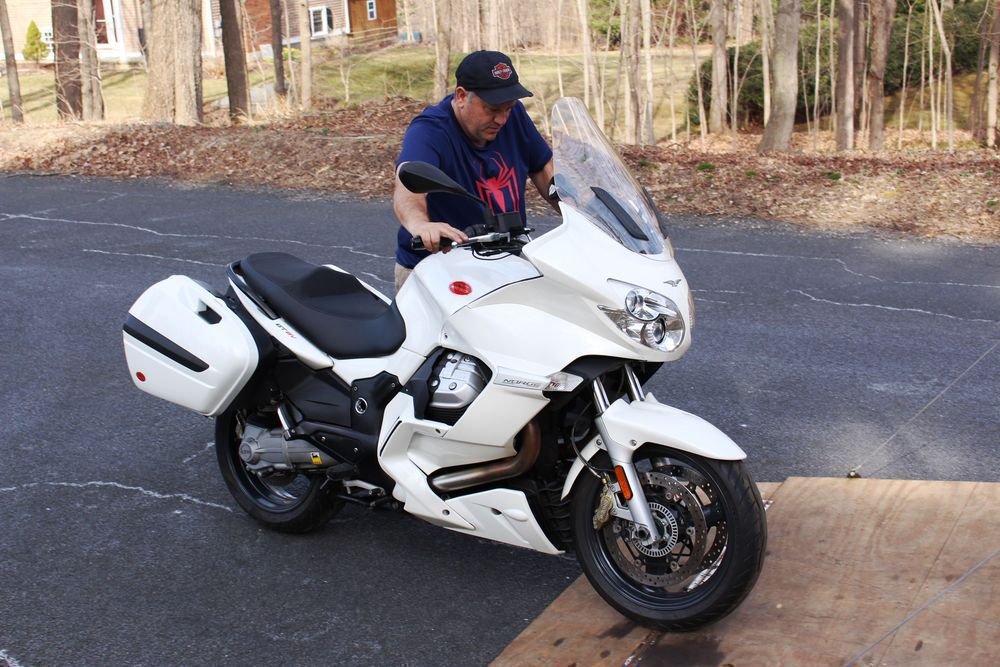 Jim Botsolis of 50 Mobile Transport admires the 2011 Moto Guzzi Norge GT 8V that he has just delivered to the RIDE-CT stable. Bud Wilkinson / Republican-American  