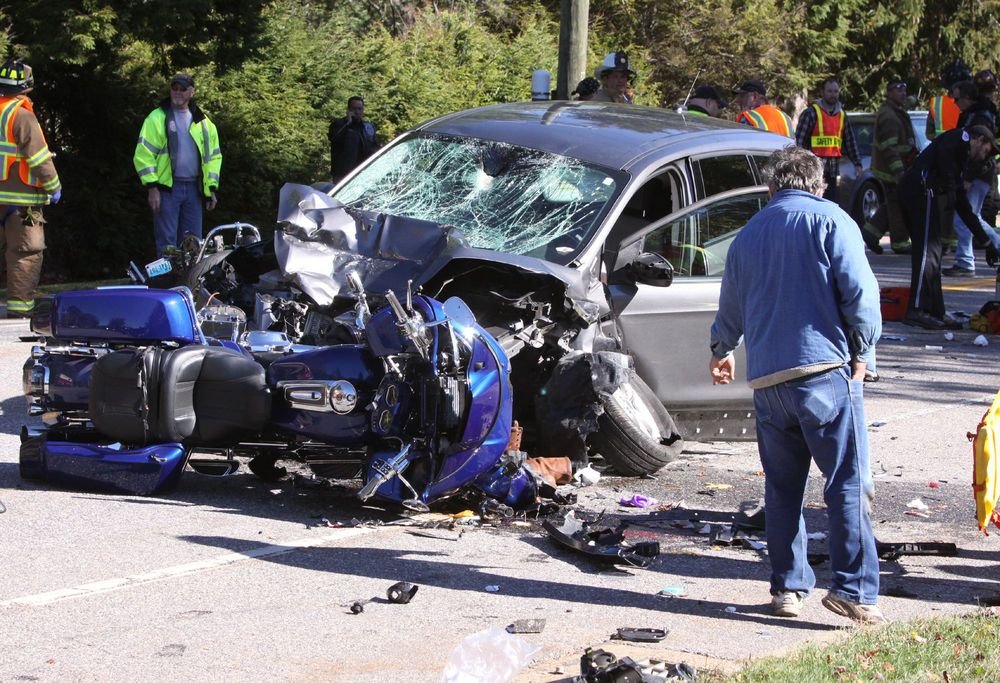 Emergency services personnel work at the scene of Sunday's crash on Route 63 in Litchfield that involved a car and four motorcycles. Aislinn Kern of Harwinton, a passenger on the motorcycle that collided head-on with the car, was killed.  John McKenna Republican-American 