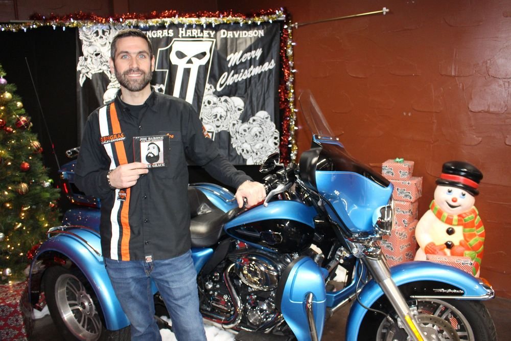 Bud Wilkinson Republican-American Gengras Harley-Davidson general manager Joe Barone displays the new CD, 'Some Grace,' by Joe Barone & The Remedies.